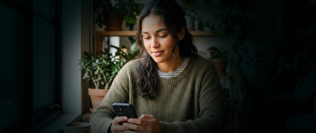Young woman reading on her phone an ADHD blog